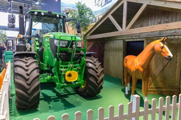 Farm tractor and horse at Farming Simulator 19 booth
