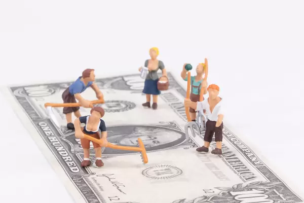 Farmers standing on a 100 dollar banknote