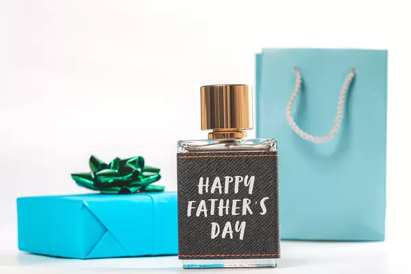 Father's day background with perfume bottle, gift box and package