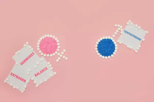 Female and male hormonal balance concept image