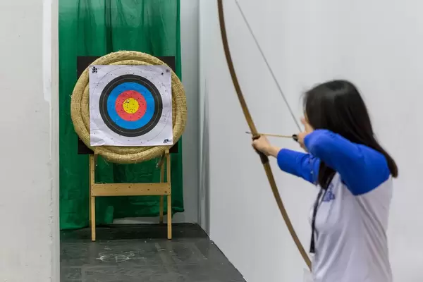 Female archer taking aim