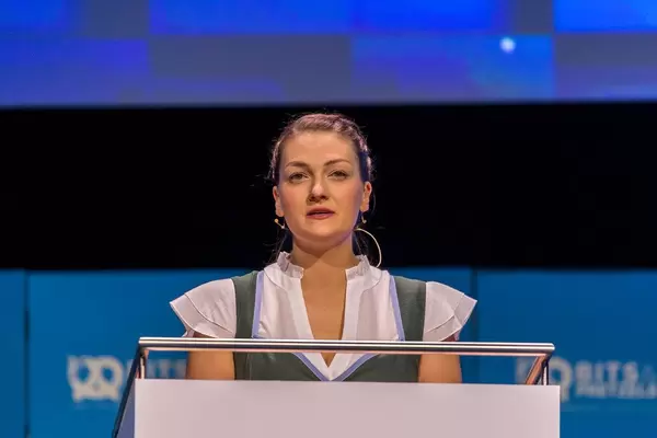 Female CSU politician Judith Gerlach wears traditional Bavarian dress and stands at the speaker's desk on the stage of the Startup-Congress Bits19 in Munich