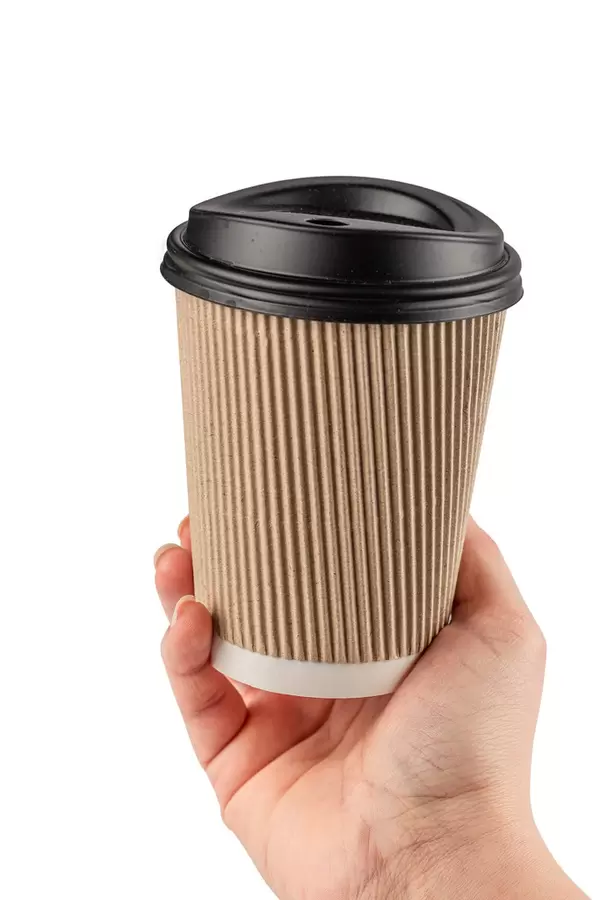 Female hand holding a coffee paper cup