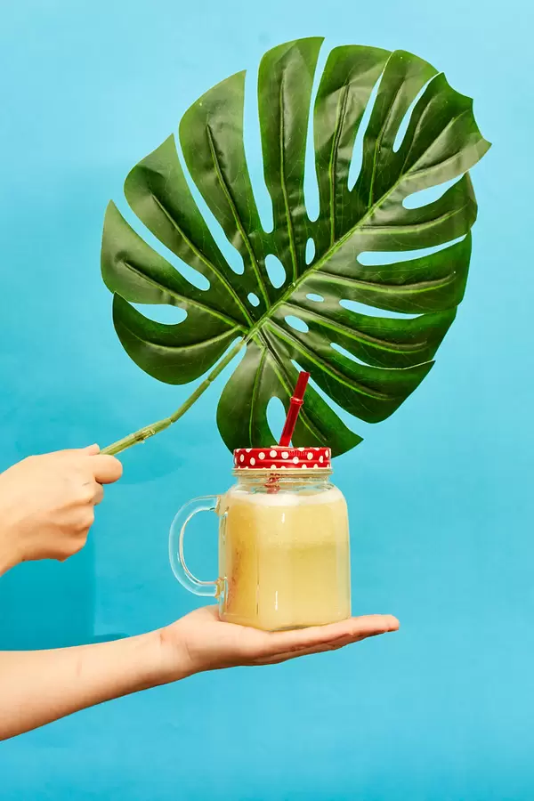 Female hand holding a fresh and cold summer smoothie