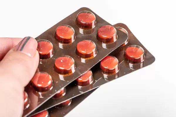 Female hand holds a blister of pills