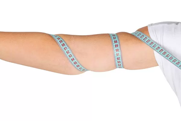 Female hand with measuring tape. Weight loss concept