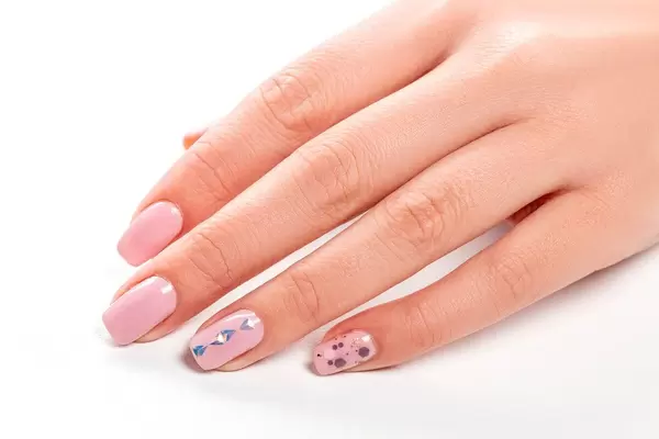 Female hand with pink manicure