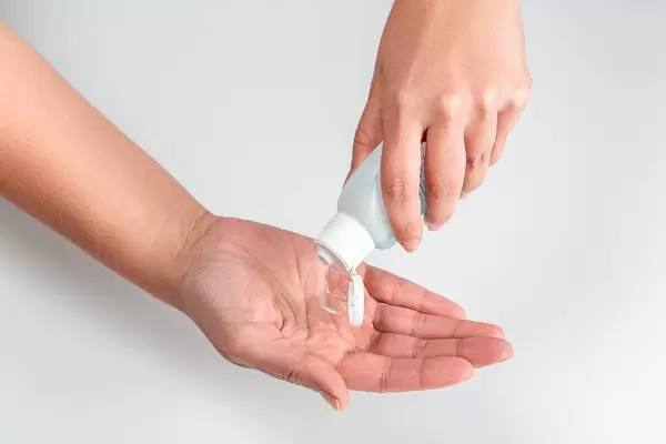 Female hands pour antiseptic fluid. The concept of individual health care