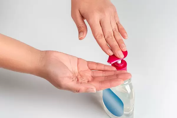 Female hands use antiseptic soap for hand disinfection