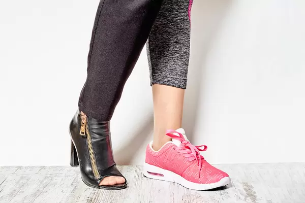 Female wearing official high-hilled shoe and sneaker