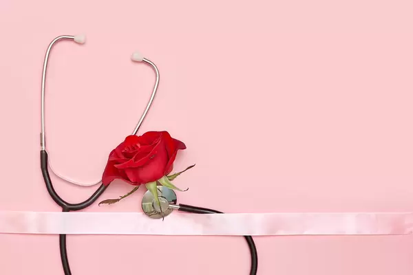 Female's health concept with stethoscope and rose