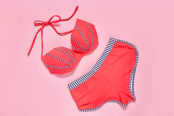 Female's swimsuit on pink background
