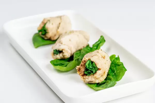 Fertig zubereitete Hähnchenrouladen mit Gewürzen und Spinatfüllung