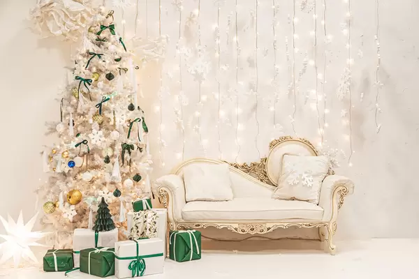 Festive light living room interior with white christmas tree, gifts, sofa and garlands