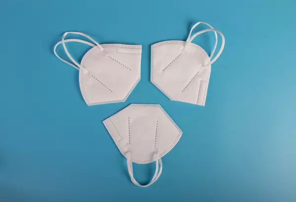 FFP2 medical face masks on blue background