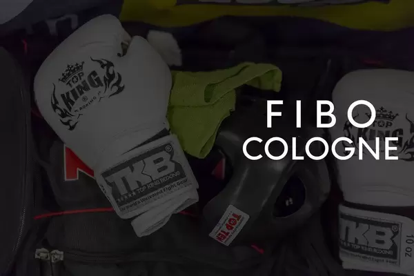 Fight gear, helmet and boxing gloves to show at the German sport- and fitness fair with the picture title "Fibo cologne"