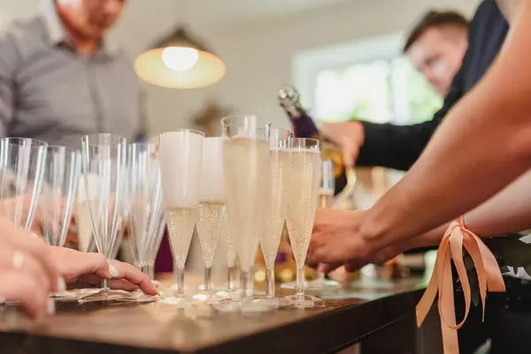 Filling Up Champagne Glases On Wedding Table