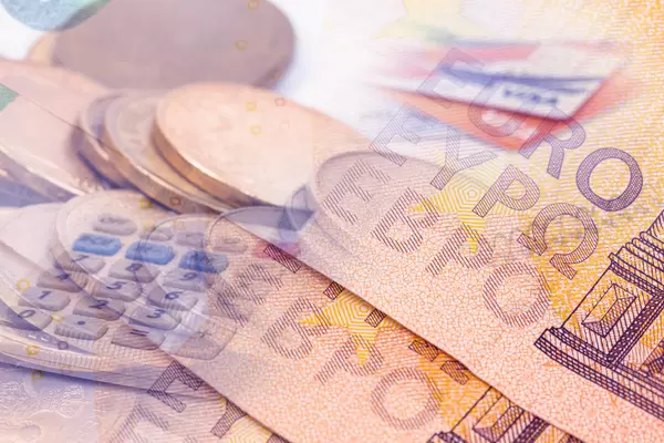 Finance concept with Euro currency and coins in the background