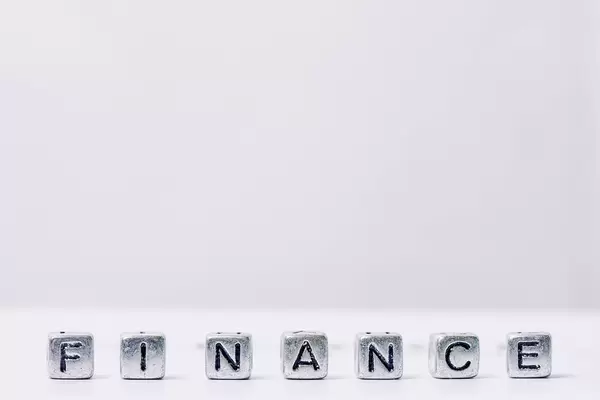 Finance word, made of miniature letter blocks on white background