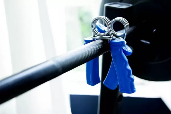 Fingerhanteln hängen auf einer Hantelstange im Fitnessstudio