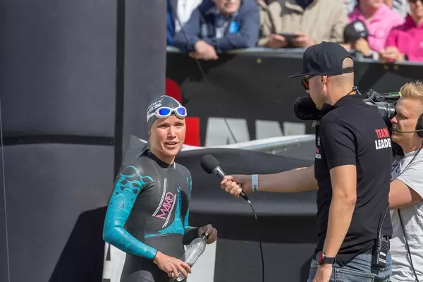 Finnish professional athlete Kaisa Sali before the start of the Ironman triathlon in Lahti, gives an interview in her wetsuit