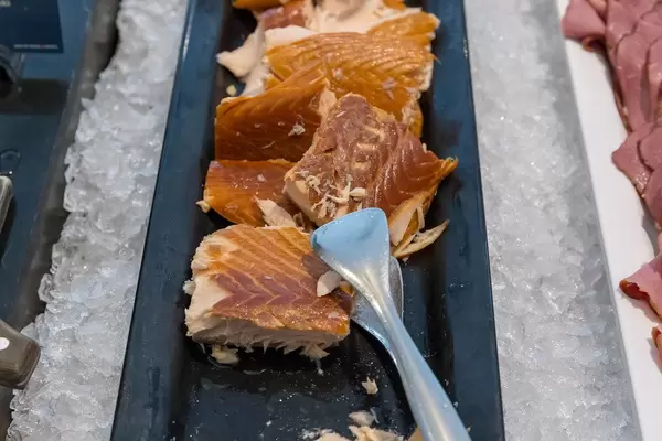 Fish at a hotel buffet, for a balanced meal, served on a black tray on ice cubes
