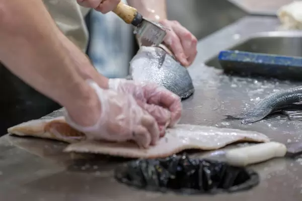 Fish sellers processing fish at Danilovsky Market in Moscow