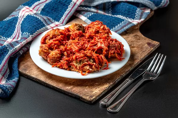 Fish slices in tomato sauce with vegetables