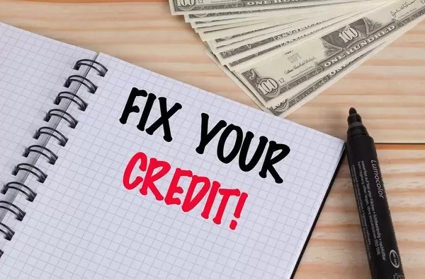 Fix your credit text in notebook and Dollar banknotes on wooden table