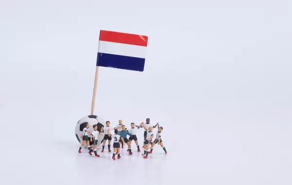 Flag of Netherlands and group of football players