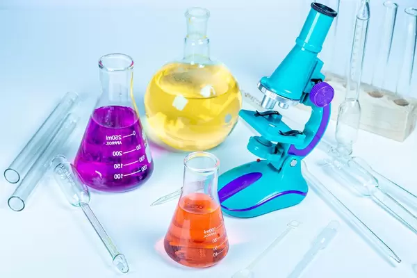 Flasks with reagents, microscope and laboratory glassware (Flip 2020)