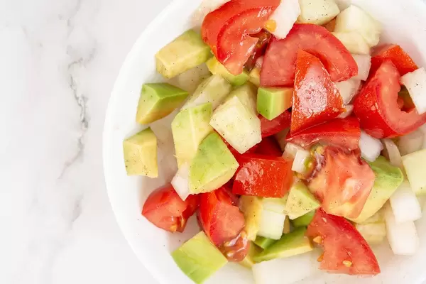 Flat lay above Avocado Tomato Onion and Cucumber Salad