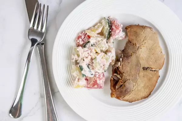Flat lay above Baked Pork Chop with Serbian Sopska Salad