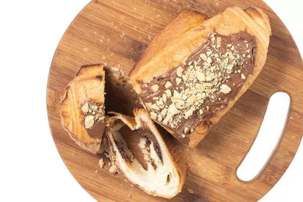 Flat lay above Bakery Pastry with Chocolate Cream and grated Hazelnuts
