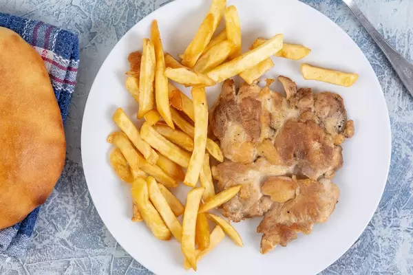 Flat lay above Chicken Drumstic with French Fries and bread