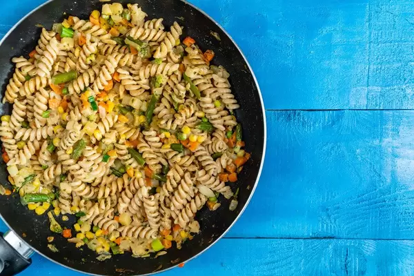 Flat lay above Cooked Vegetables with Pasta with Copy Space (Flip 2020)