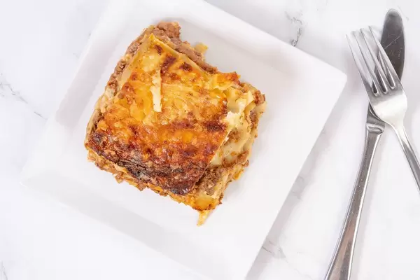 Flat lay above delicious Lasagna on the plate (Flip 2019)