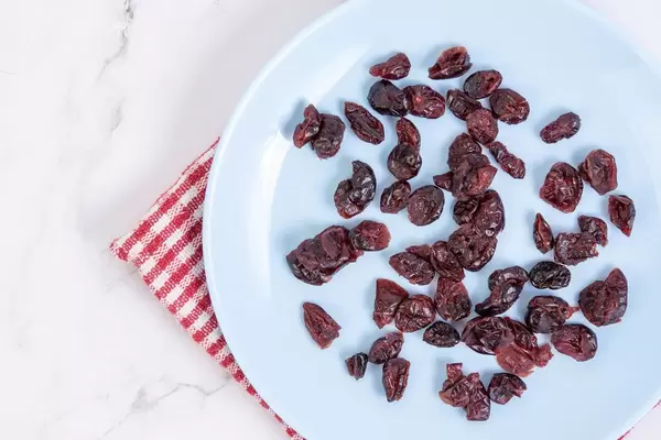 Flat lay above Dried Cranberries on the blue plate