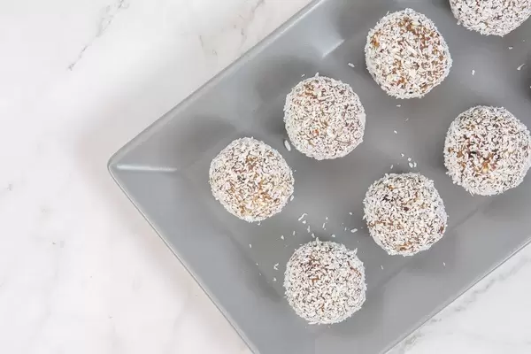 Flat lay above Energy Balls with Date Palm fruits Almonds Walnuts and Coconut