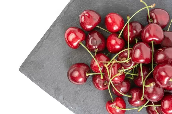 Flat lay above Fresh Cherries on the Stone Tray