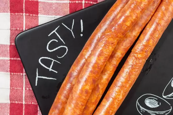 Flat lay above homemade Red Sausages on the black tray