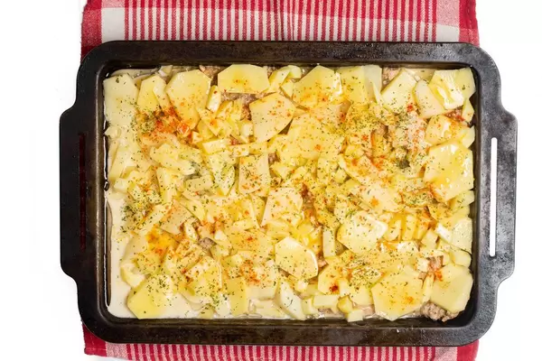 Flat lay above raw potatoes moussaka