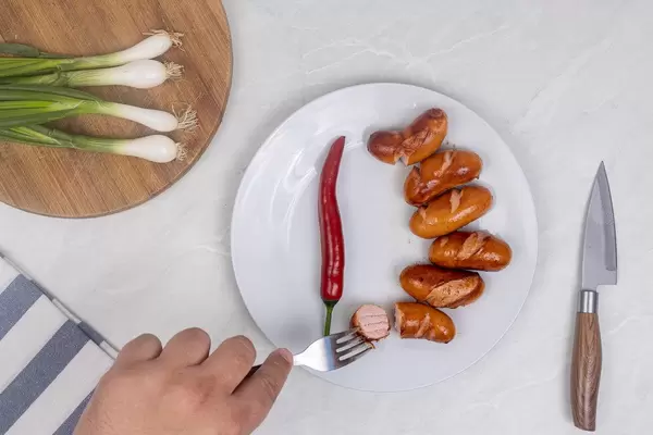 Flat lay above served meal with Fried Sausages and young onions