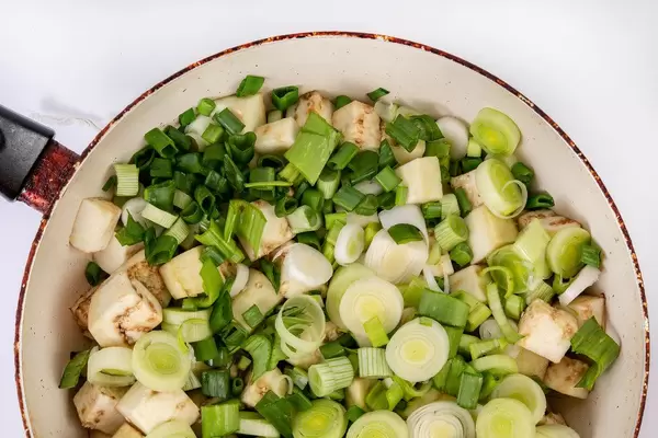 Flat lay above sliced Eggplant with Leek in the frying pan (Flip 2019)
