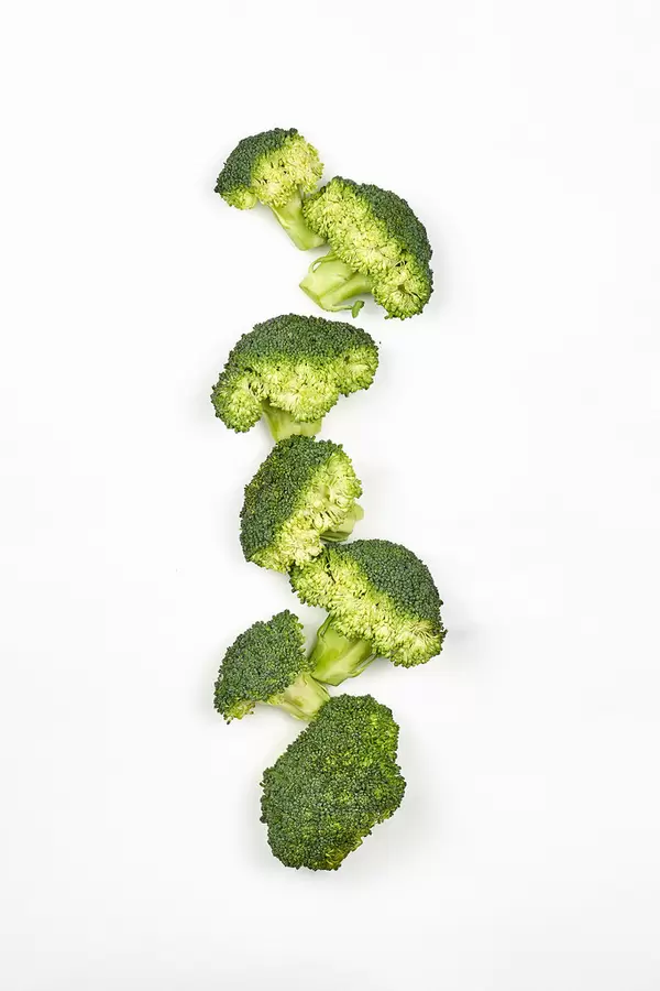 Flat lay composition with fresh green broccoli on white background
