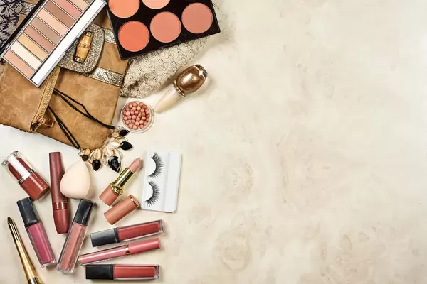 Flat lay image of professional make-up cosmetic products on pastel marble background