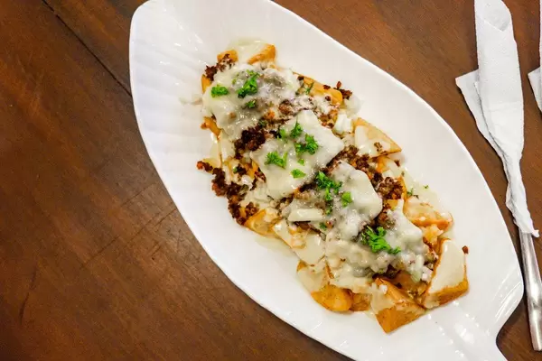 Flat lay of baked potatoes with cream sauce (Flip 2019)