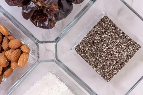 Flat lay of Peanut butter Almonds Coconut Chia Seeds and Dates (Flip 2019)