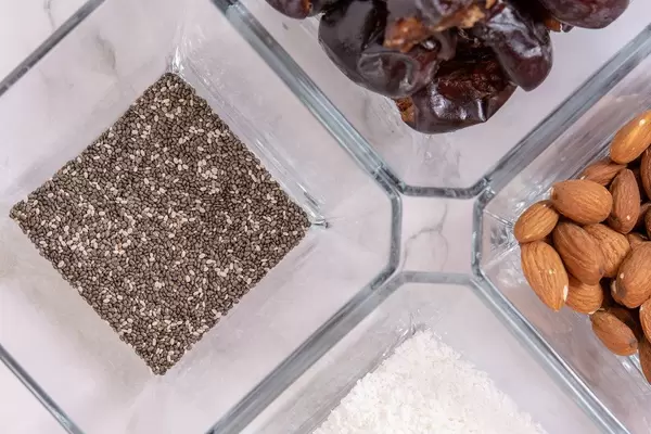 Flat lay of Peanut butter Almonds Coconut Chia Seeds and Dates