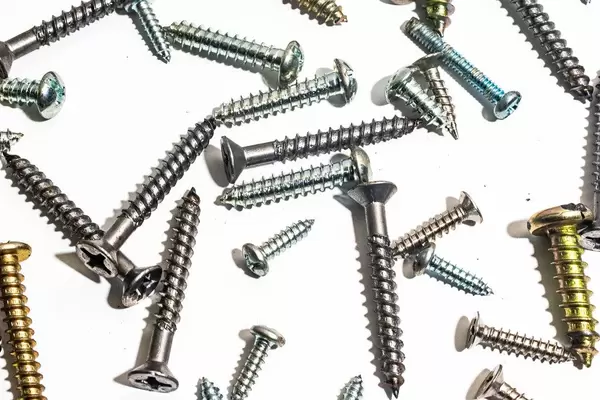 Flat lay of screws on white surface (Flip 2019)